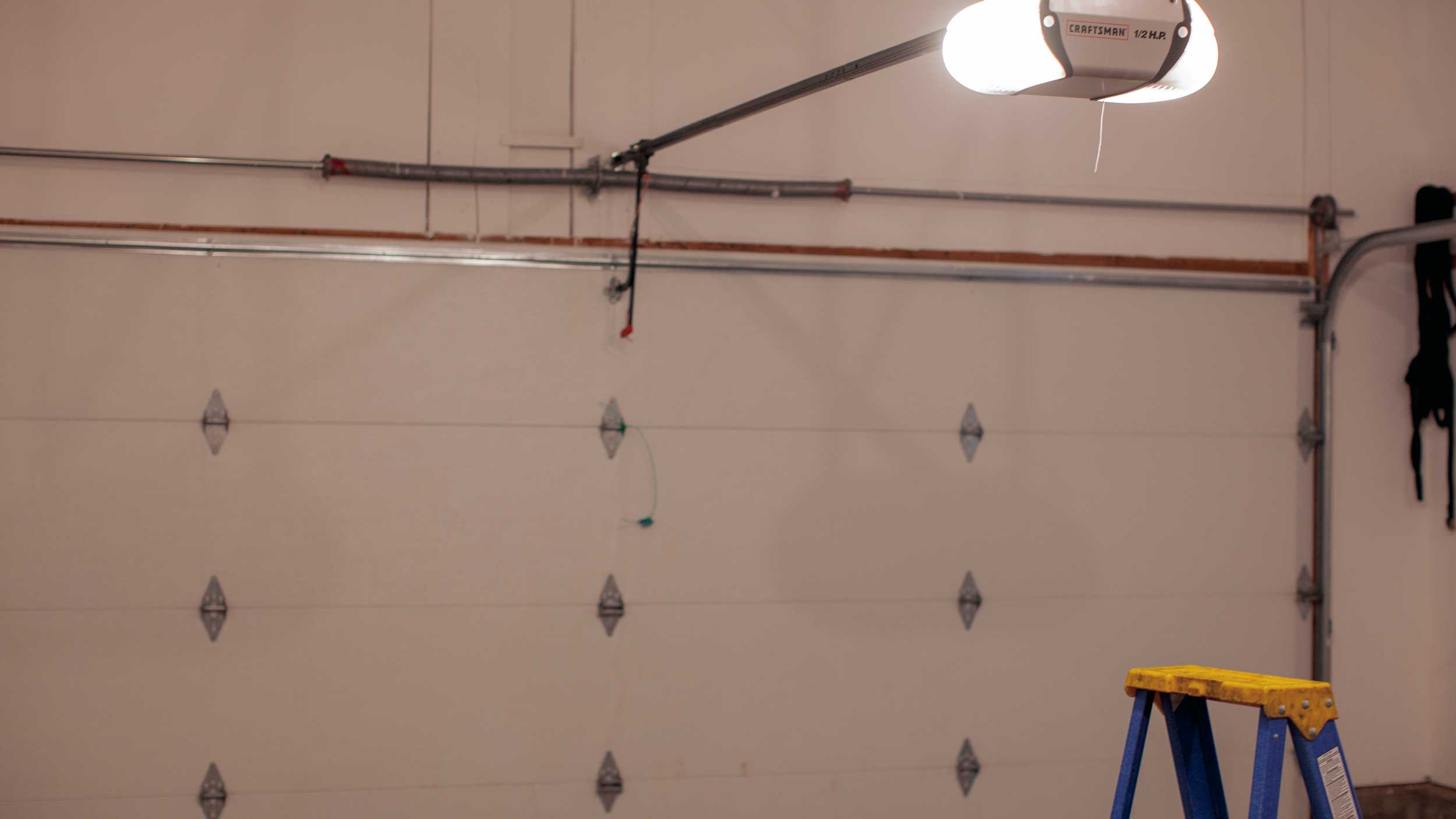 Dented panel of a garage door